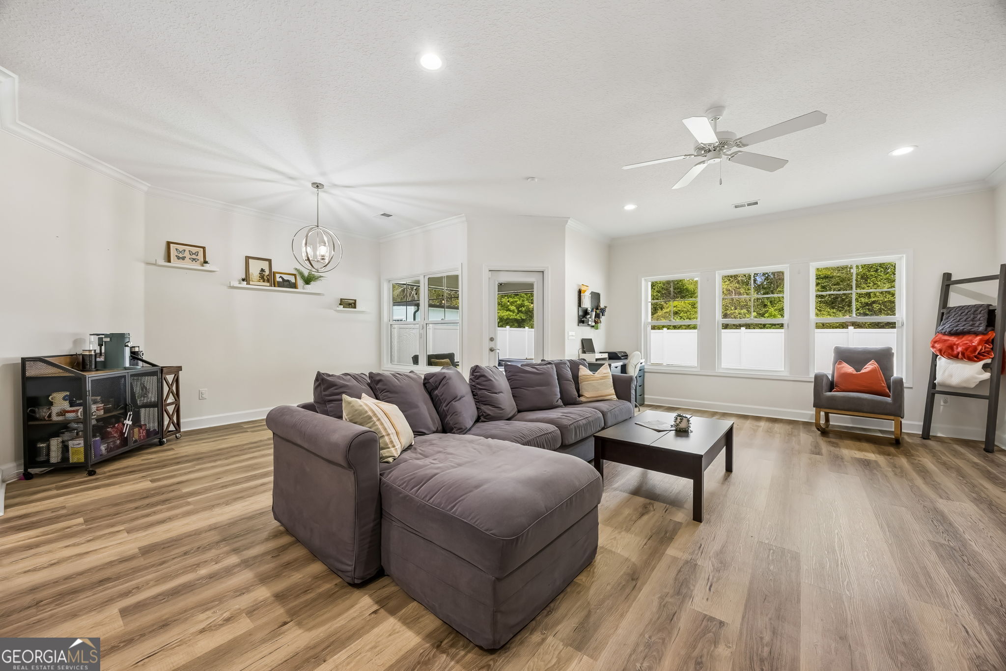 152 Verano Street Kingsland, GA 31548 - Photo 8 of 55 a living room with furniture and a wooden floor