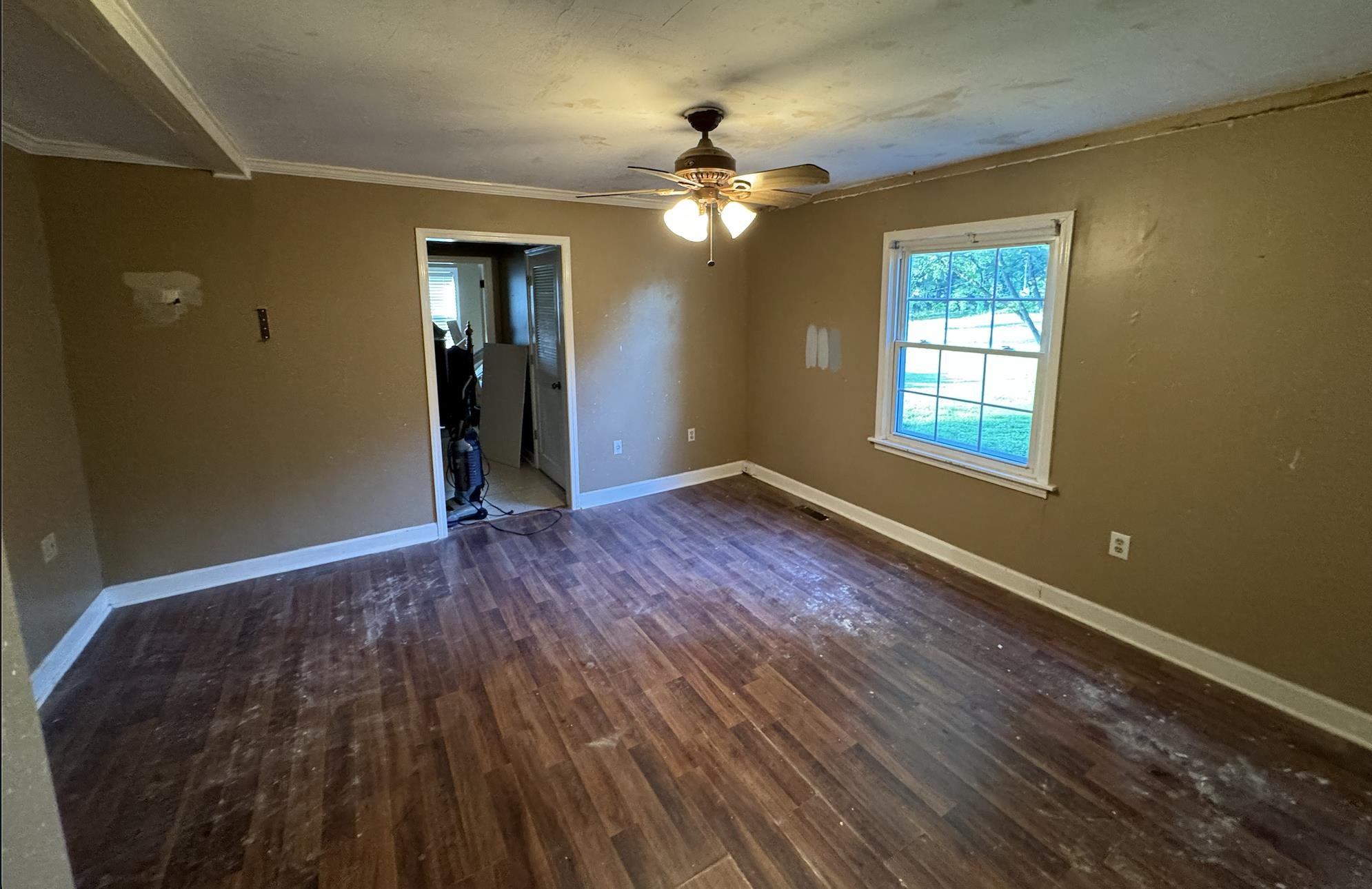 1336 Dunlap Orphanage Road Brighton, TN 38011 - Photo 12 of 14 Spare room with hardwood / wood-style floors, ceiling fan, and crown molding
