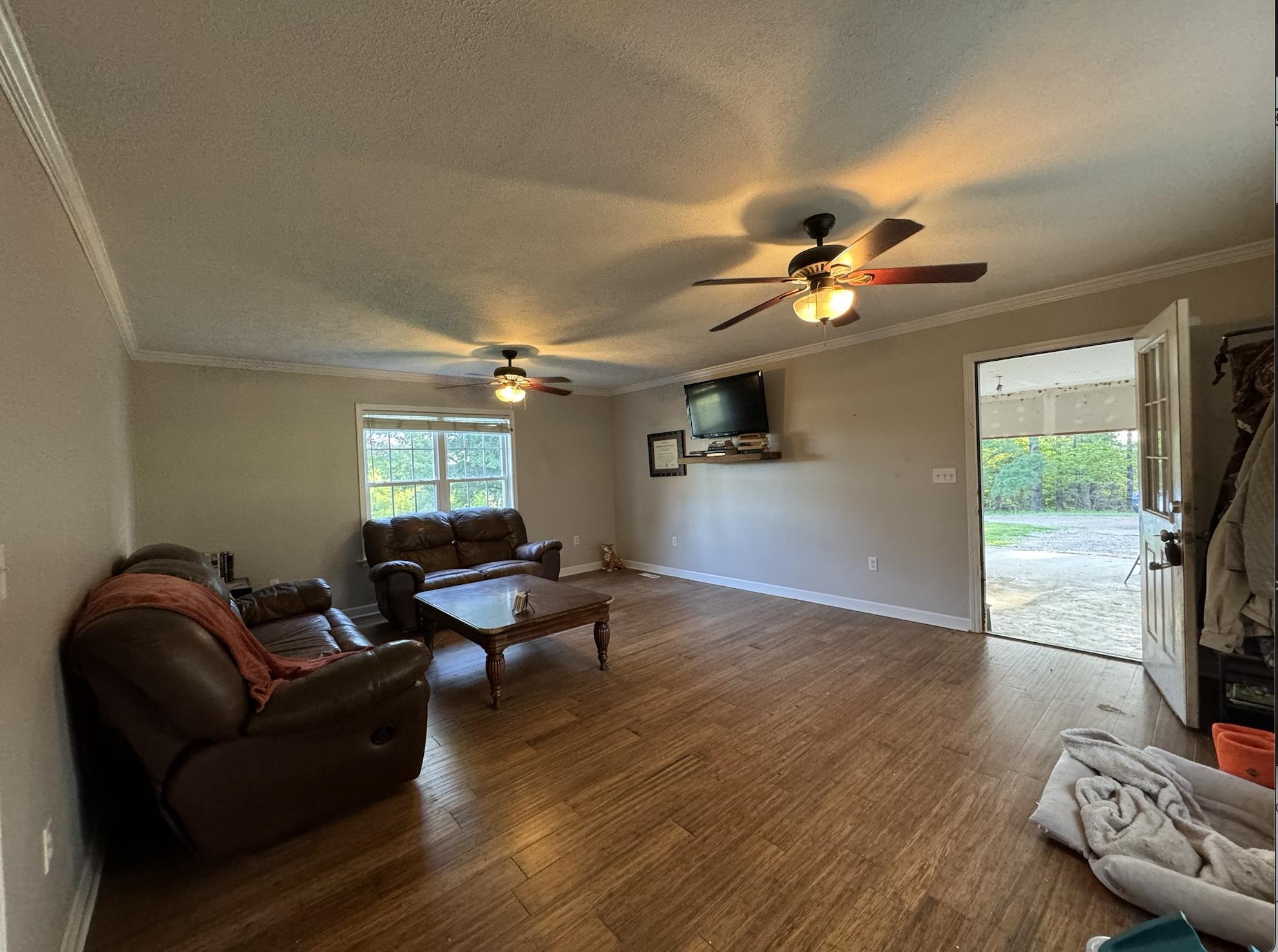 1336 Dunlap Orphanage Road Brighton, TN 38011 - Photo 8 of 14 Living room with a textured ceiling, ceiling fan, crown molding, and hardwood / wood-style flooring