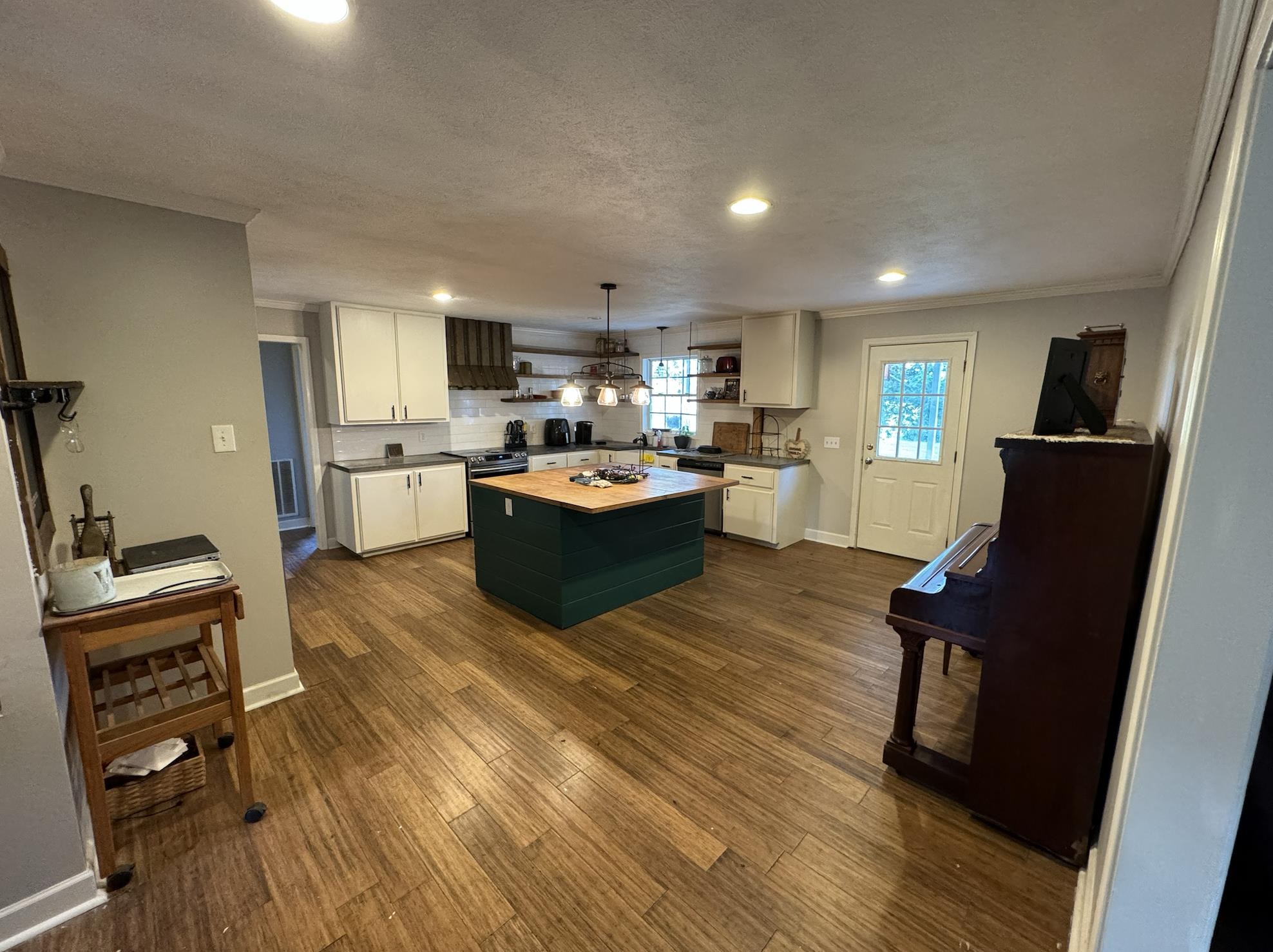 1336 Dunlap Orphanage Road Brighton, TN 38011 - Photo 10 of 14 Kitchen with wooden counters, white cabinets, a kitchen island, and dark hardwood / wood-style flooring