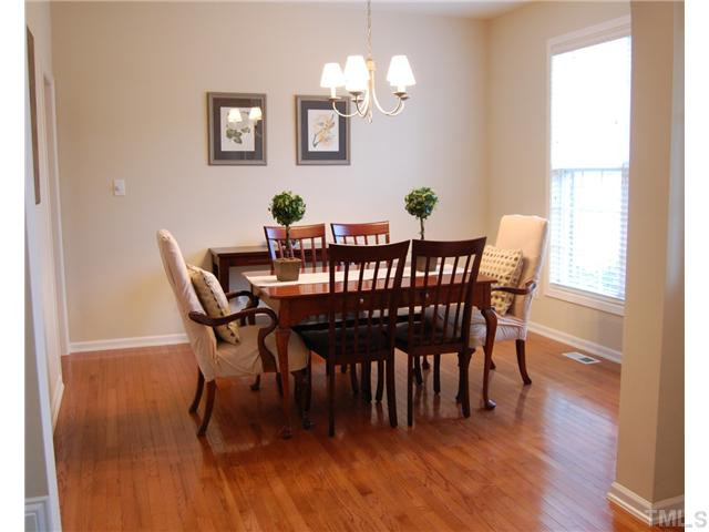 8413 Dunnington Circle Raleigh, NC 27613 - Photo 7 of 21 a view of a dining room with furniture and wooden floor