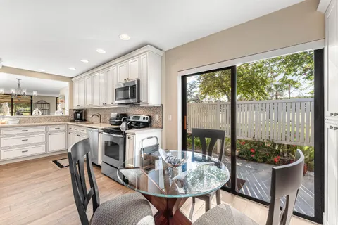 a bathroom with a granite countertop sink a toilet a mirror and shower
