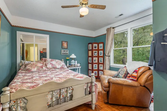 a bed sitting in a bedroom next to a window