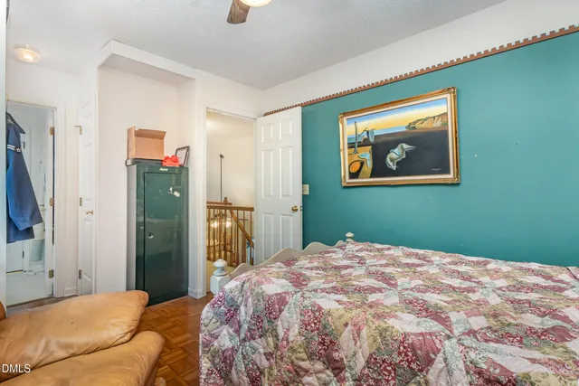 a bedroom with a bed couch and a large window