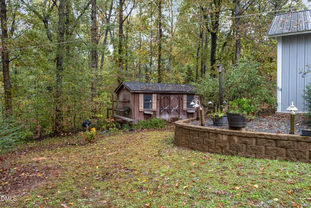 a view of a house with pool and sitting area