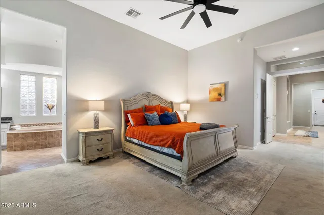 a bathroom with a bathtub double sink and mirror