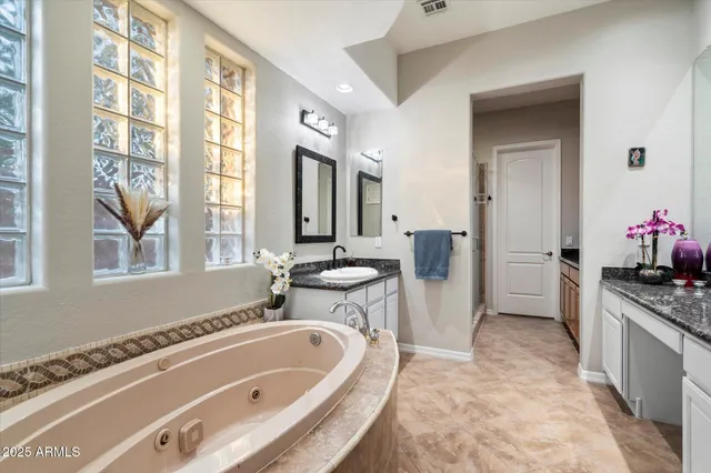 a bathroom with a granite countertop sink a toilet and shower