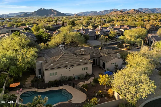 an aerial view of residential houses with outdoor space