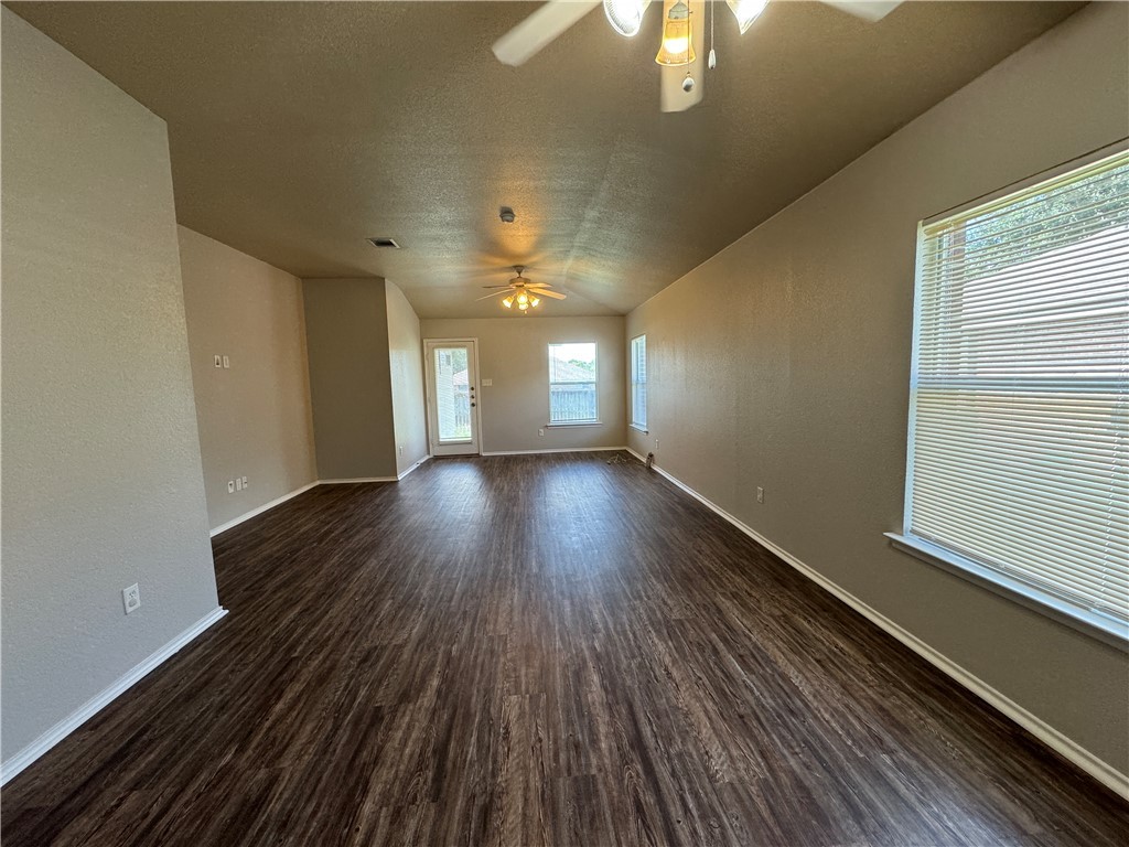 921 Whitewing Lane College Station, TX 77845 - Photo 6 of 14 a view of an empty room with wooden floor and a window