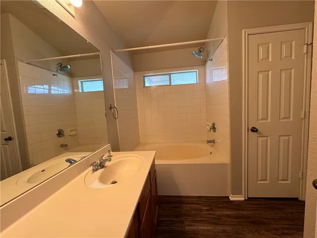 a bathroom with a sink and shower