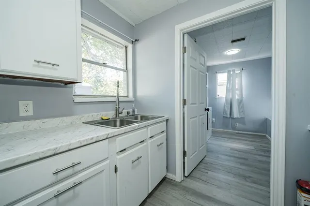 a bathroom with a granite countertop sink mirror and window
