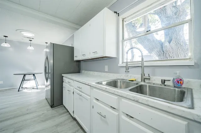 a kitchen with white cabinets and a sink