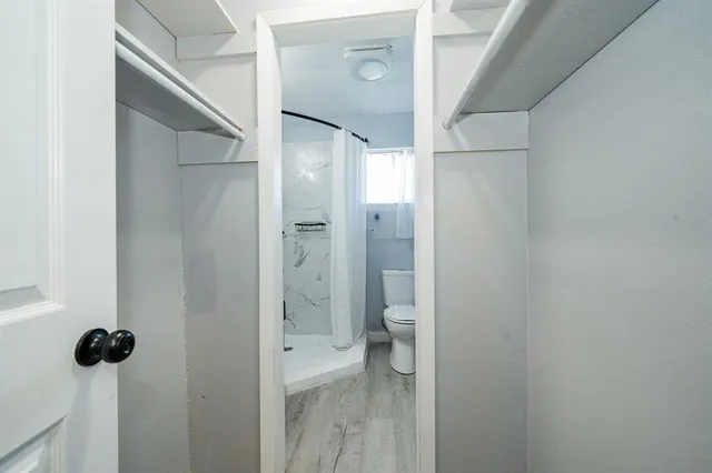 a bathroom with a granite countertop sink mirror and toilet