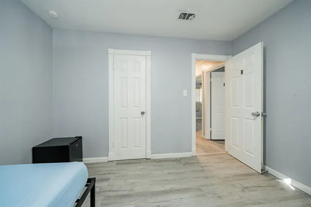 a bedroom with a bed and a bathroom