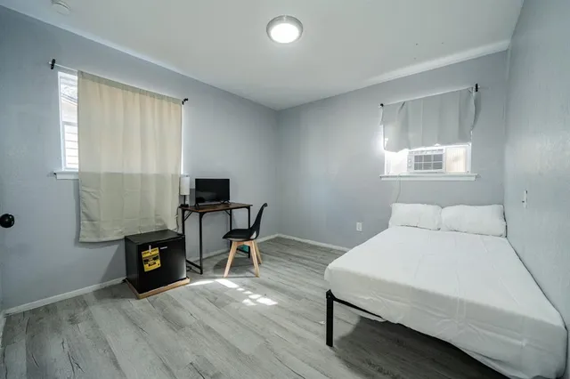 a bedroom with a bed and a window