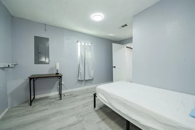 a bedroom with a bed and a table