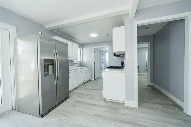 a kitchen with a refrigerator and a sink