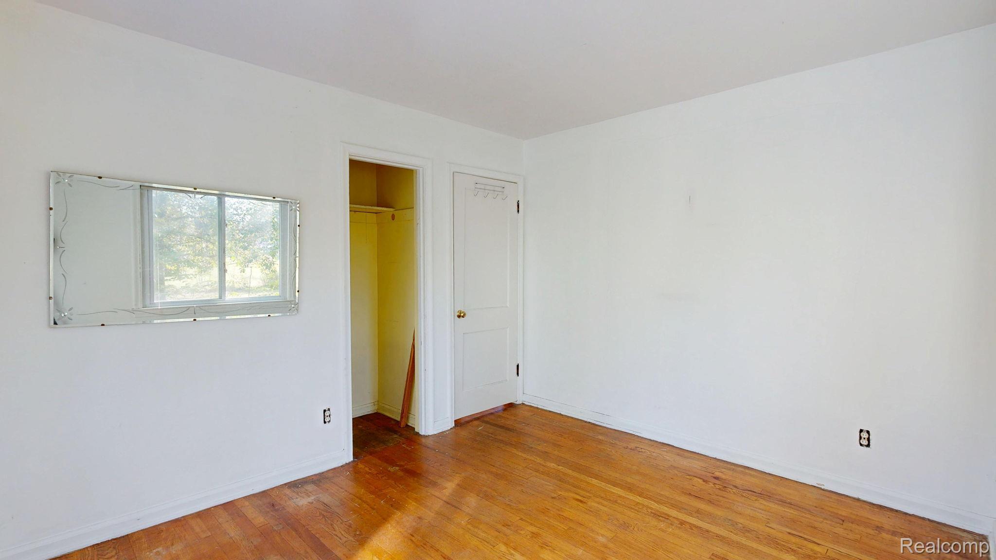 4455 North Genesee Road Flint, MI 48506 - Photo 15 of 47 Unfurnished bedroom featuring light wood-type flooring and a spacious closet