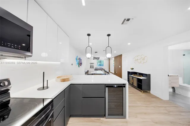 a kitchen with a sink stainless steel appliances and cabinets