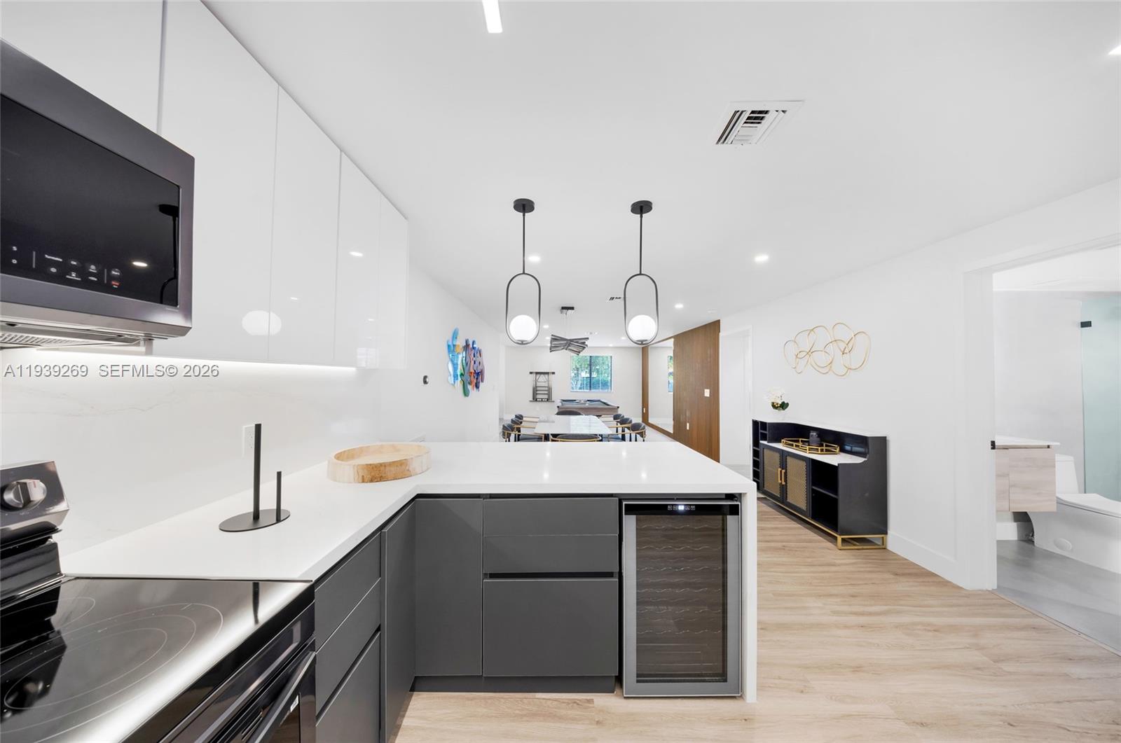 111 Northwest 53rd Street Miami, FL 33127 - Photo 12 of 53 a kitchen with a sink stainless steel appliances and cabinets