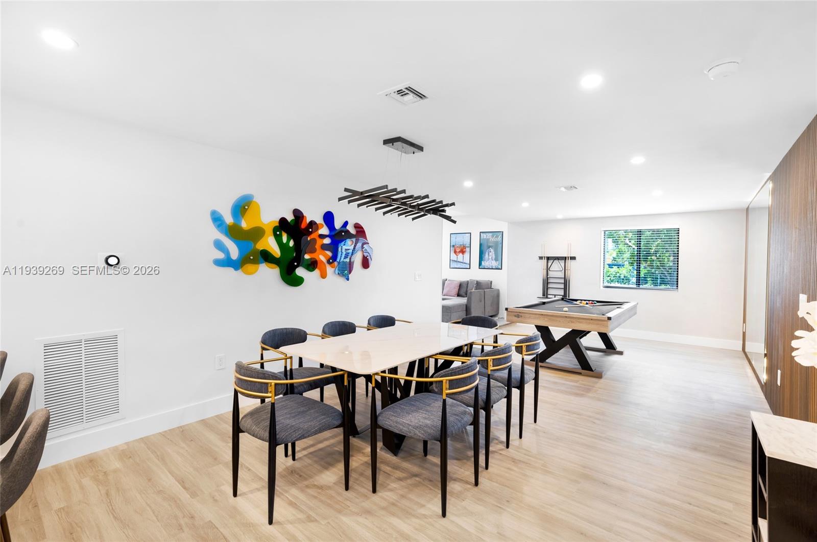 111 Northwest 53rd Street Miami, FL 33127 - Photo 16 of 53 a view of a dining room with furniture and wooden floor