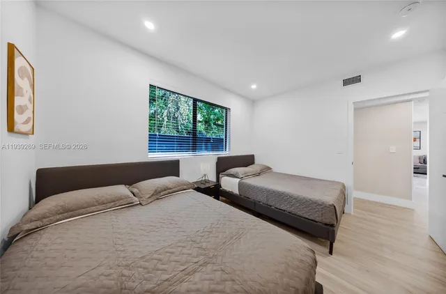 a bedroom with bed and a window