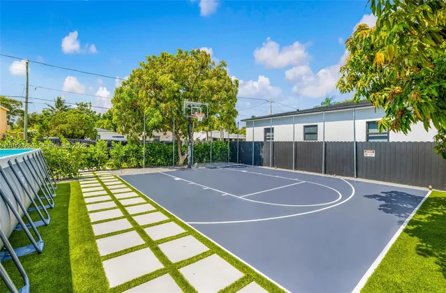 a view of backyard with tub and garage