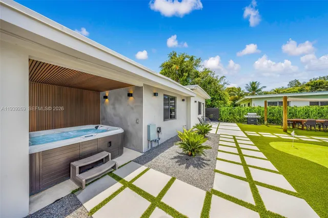 a view of a backyard with swimming pool