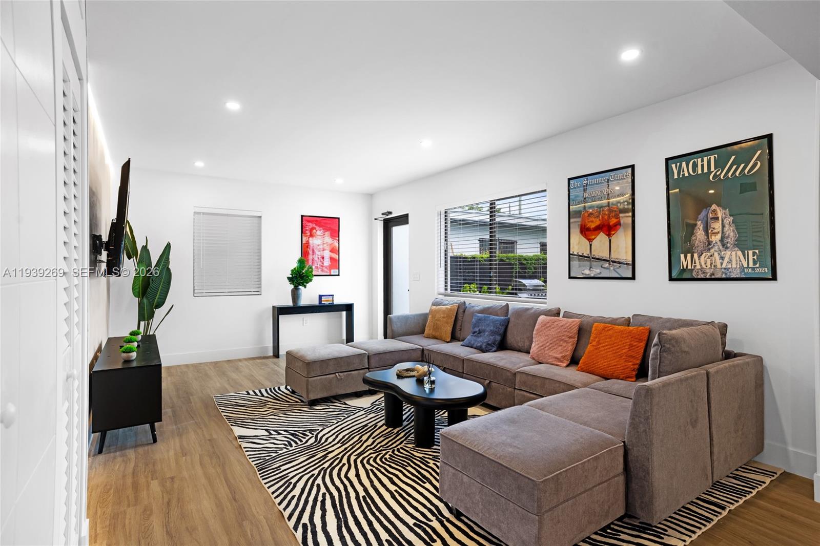 111 Northwest 53rd Street Miami, FL 33127 - Photo 6 of 53 a living room with furniture a rug and a potted plant