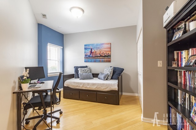 757 West 14th Street, Unit 1B Chicago, IL 60607 - Photo 13 of 13 a bedroom with a bed a bookshelf and a book shelf