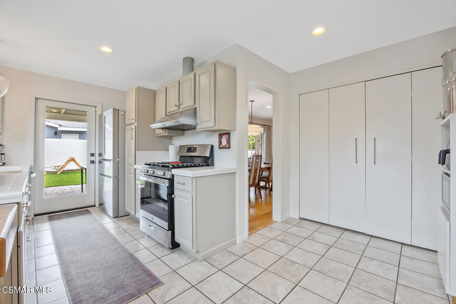 6657 Quartz Avenue Winnetka, CA 91306 - Photo 11 of 26 a kitchen with cabinets and a stove top oven