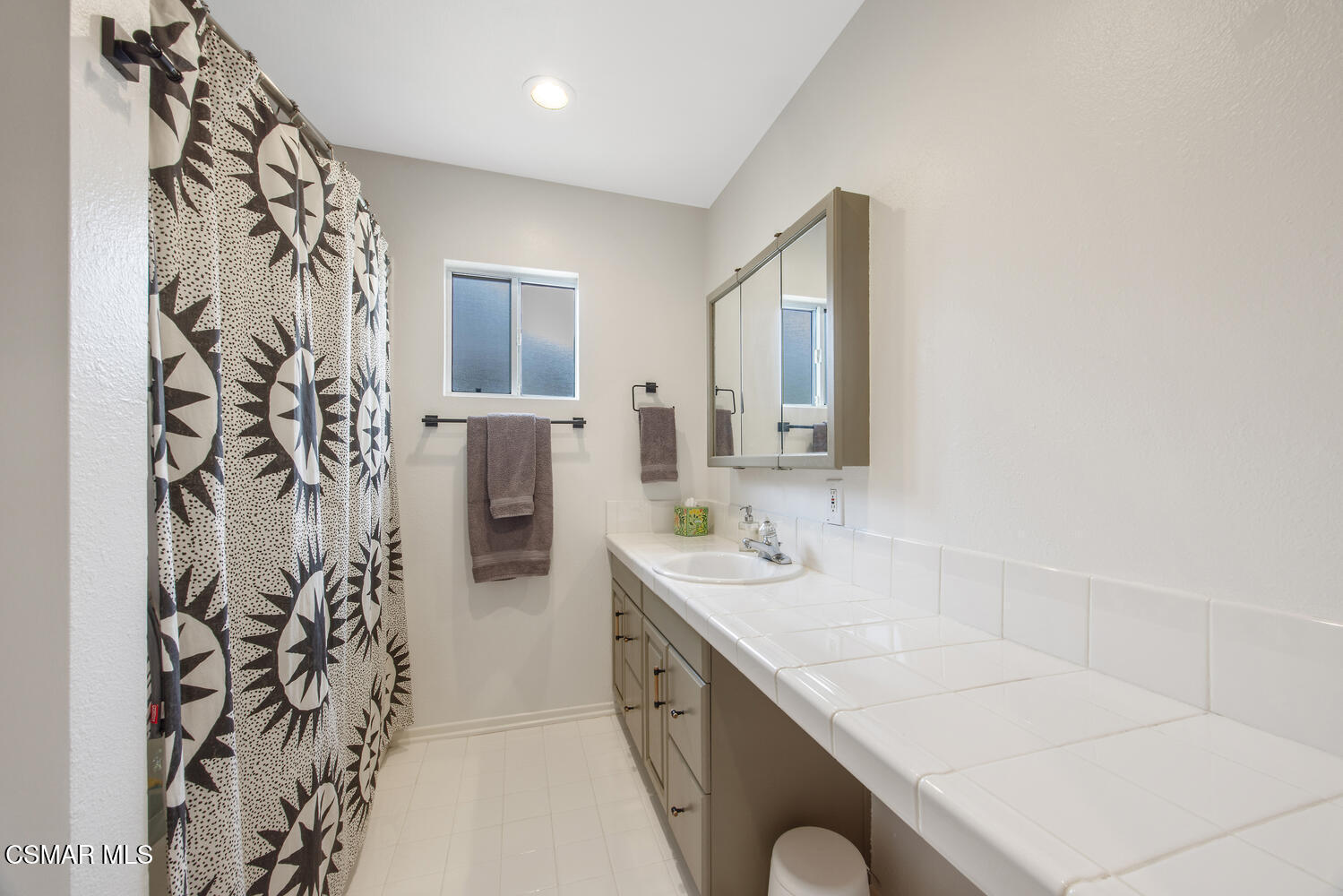 6657 Quartz Avenue Winnetka, CA 91306 - Photo 18 of 26 a bathroom with a sink and a mirror