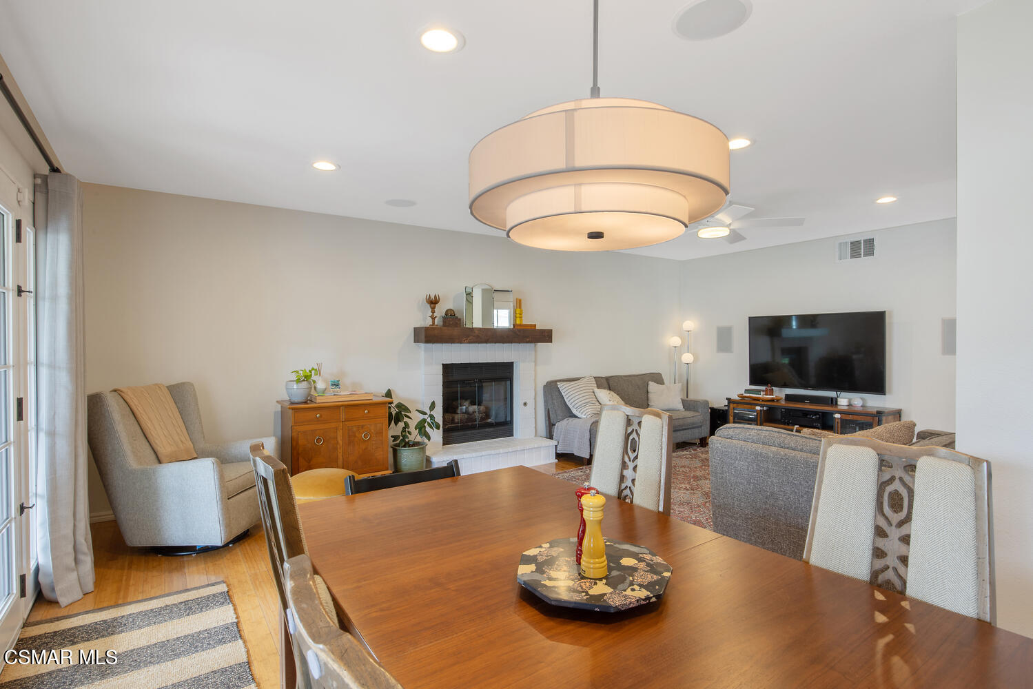 6657 Quartz Avenue Winnetka, CA 91306 - Photo 5 of 26 a living room with furniture a flat screen tv and kitchen view
