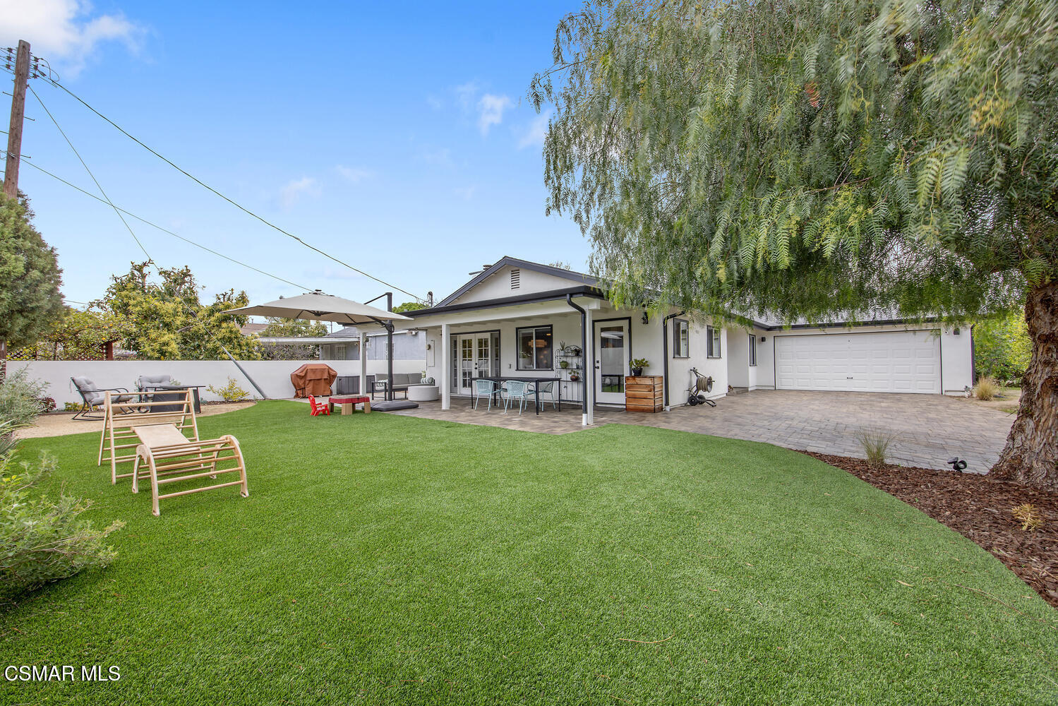 6657 Quartz Avenue Winnetka, CA 91306 - Photo 6 of 26 a front view of a house with a garden and porch