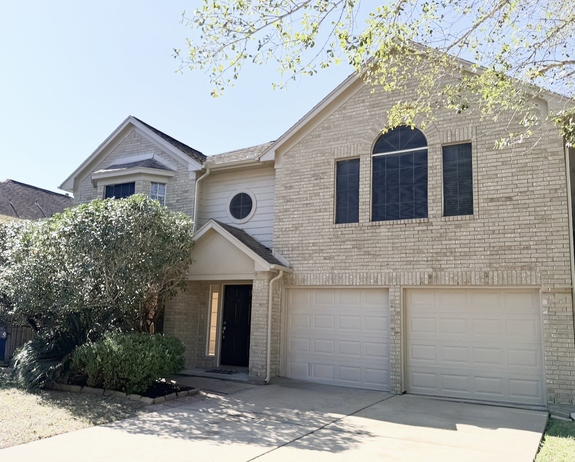 245 North Ranch House Road Angleton, TX 77515 - Photo 2 of 19 This inviting home features a classic brick exterior and a welcoming front entrance shaded by mature trees. Inside, you'll find bright, airy spaces perfect for comfortable living.