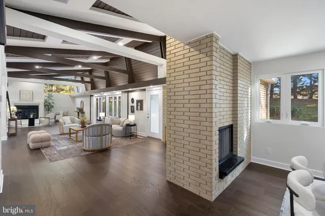 a living room with furniture a fireplace and a table