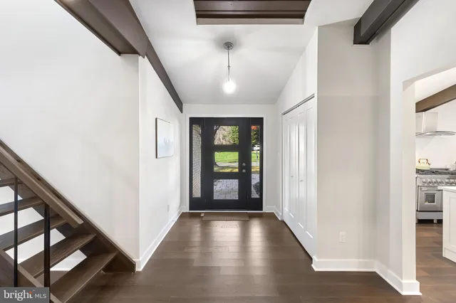 a kitchen with stainless steel appliances kitchen island granite countertop a stove a refrigerator a sink dishwasher and white cabinets with wooden floor