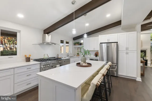 a kitchen with a sink a stove and cabinets