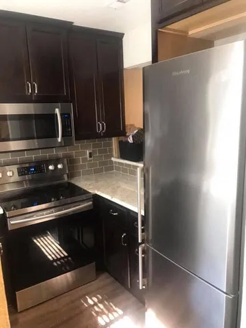 a kitchen with a sink and steel appliances