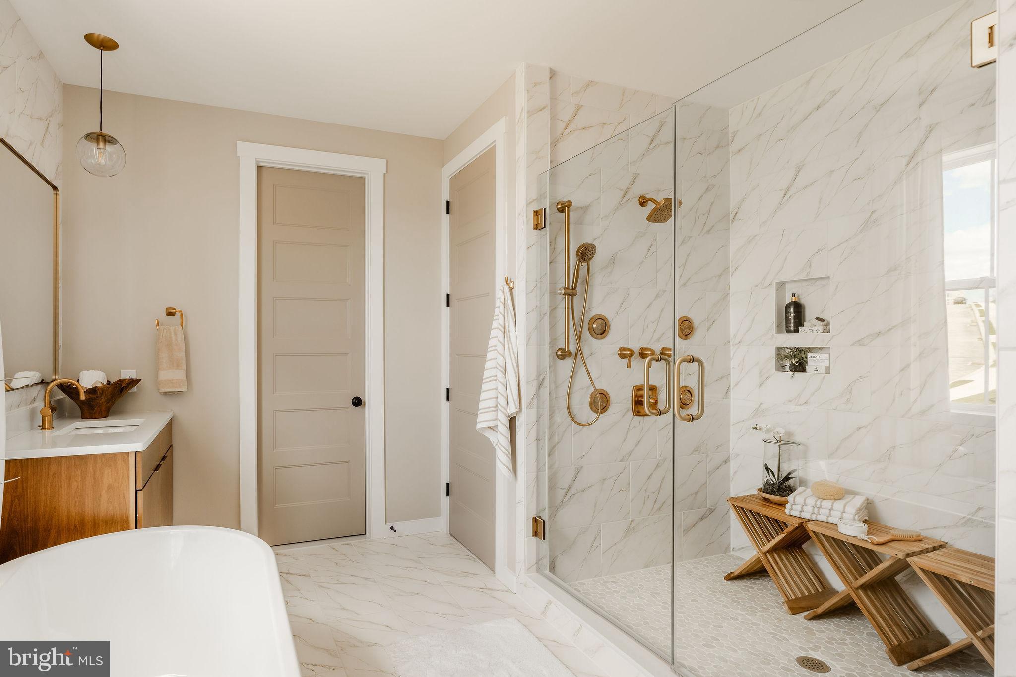 350 Village Road, Unit HAWTHORNE Strasburg, PA 17579 - Photo 33 of 45 a bathroom with a sink a toilet a glass door shower and mirror