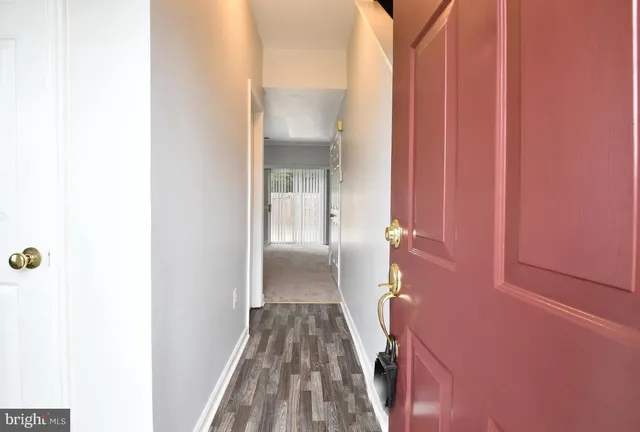 a view of hallway with wooden floor
