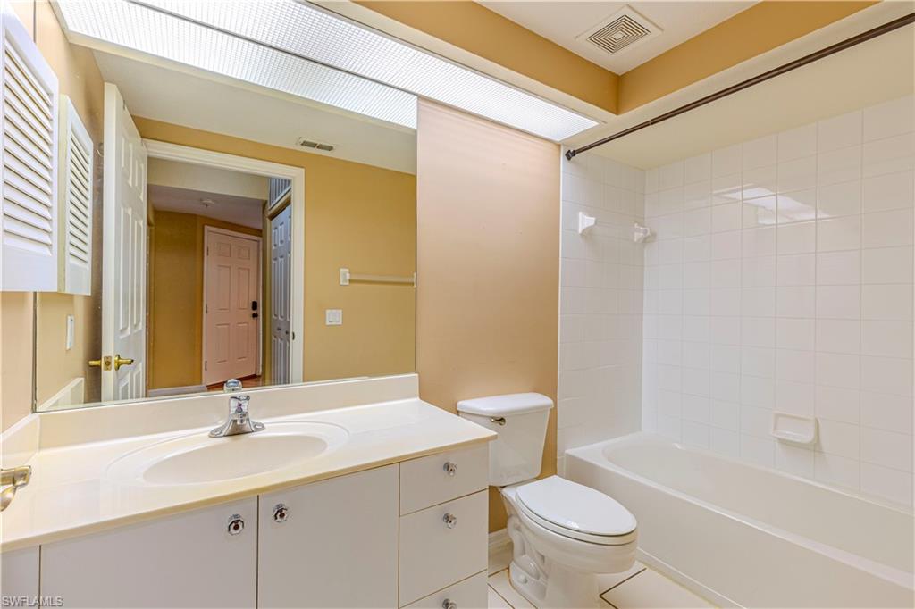 6914 Satinleaf Road North, Unit 102 Naples, FL 34109 - Photo 13 of 24 Full bathroom featuring vanity, shower / washtub combination, and tile patterned floors