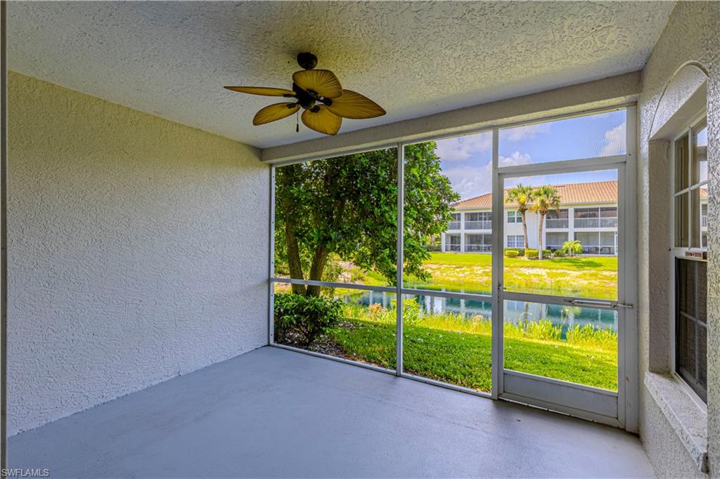 6914 Satinleaf Road North, Unit 102 Naples, FL 34109 - Photo 15 of 24 Unfurnished sunroom with a ceiling fan and a water view