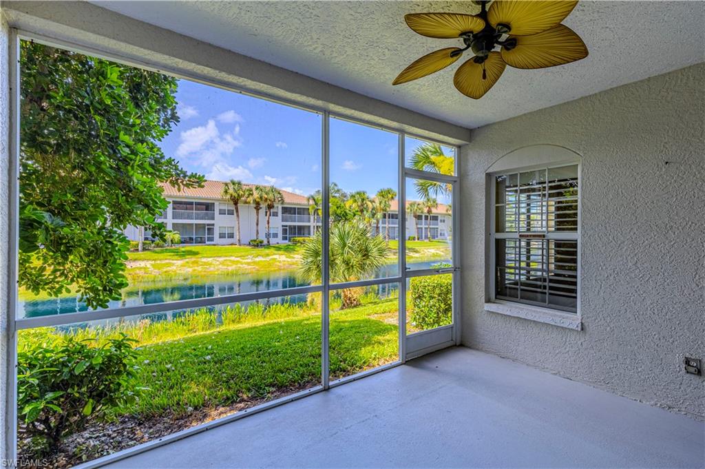 6914 Satinleaf Road North, Unit 102 Naples, FL 34109 - Photo 16 of 24 Unfurnished sunroom featuring a water view