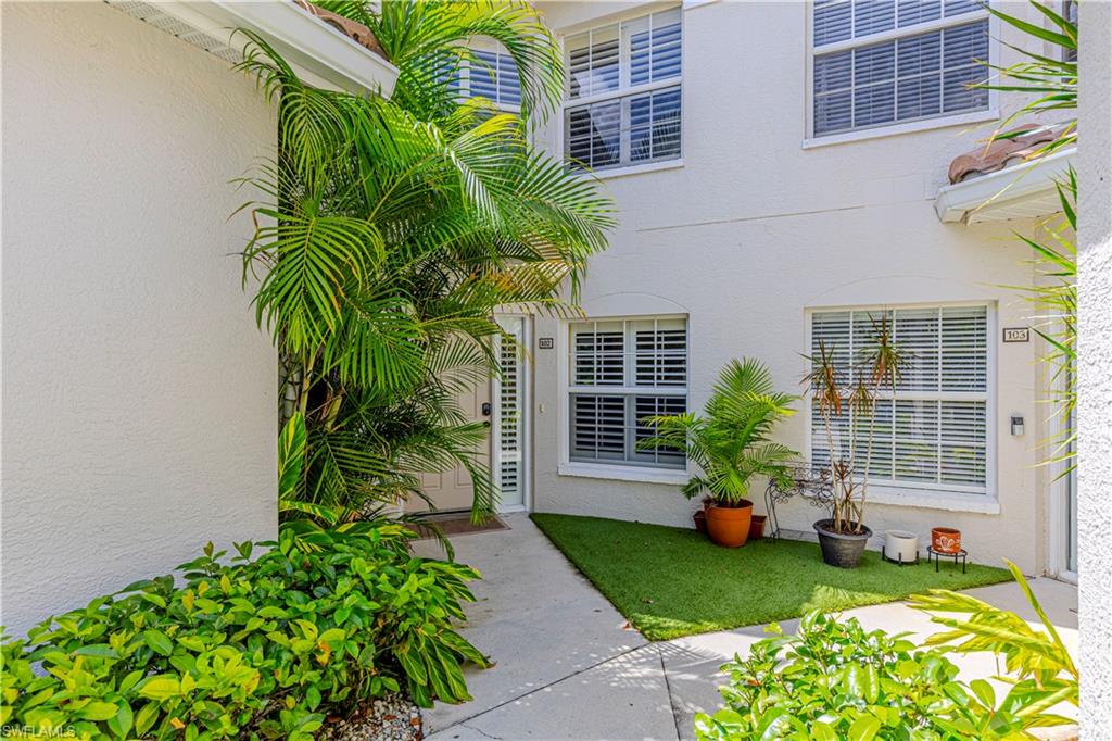 6914 Satinleaf Road North, Unit 102 Naples, FL 34109 - Photo 19 of 24 Doorway to property with stucco siding