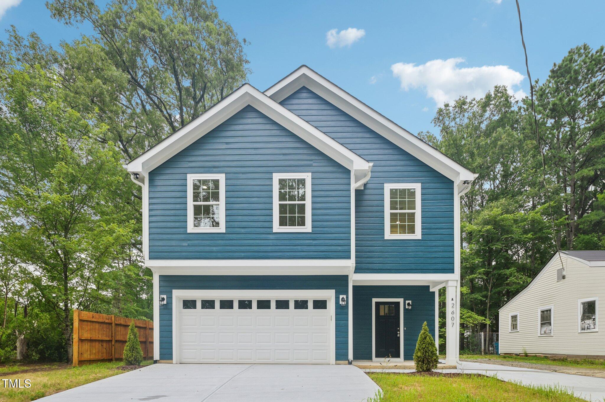 a view of a house with a yard and potted plants