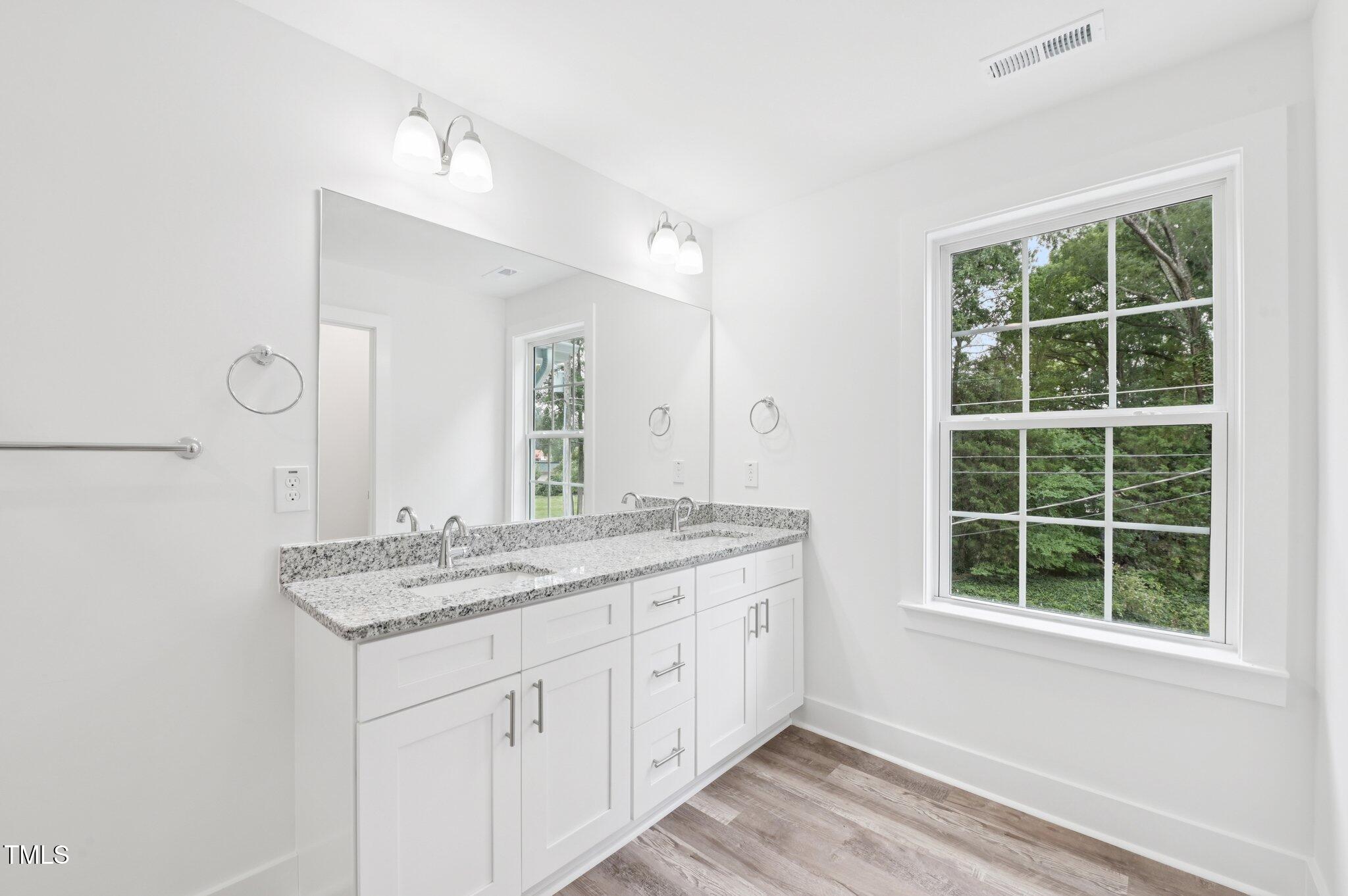 2607 Duke Homestead Road, Unit A Durham, NC 27705 - Photo 12 of 27 a bathroom with a granite countertop sink and a window