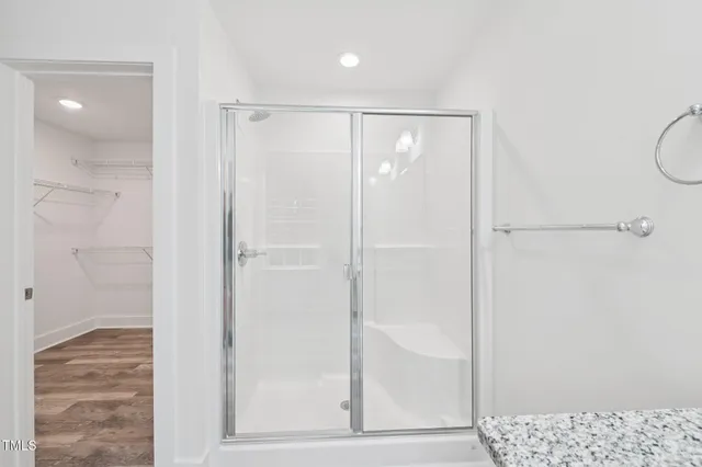 a bathroom with a shower and a glass door