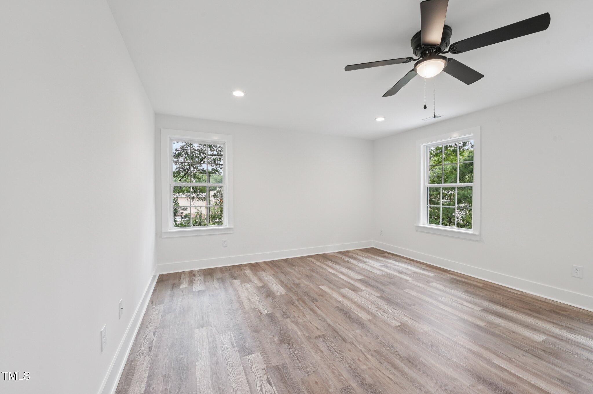 2607 Duke Homestead Road, Unit A Durham, NC 27705 - Photo 17 of 27 wooden floor in an empty room with a window