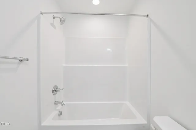 a bathroom with a shower and a toilet